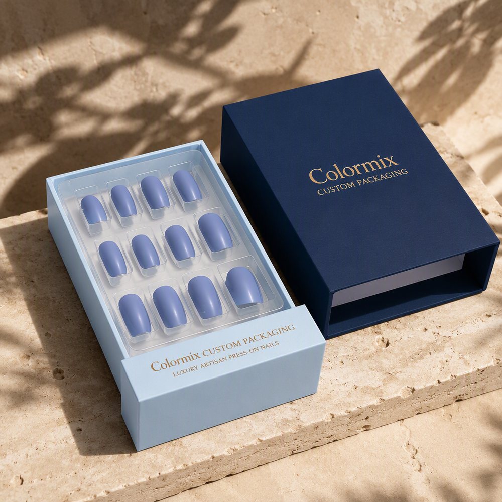 Navy lid and pale blue tray holding twelve press-on nail tips in moulded cavities, gold foil Colormix logo
