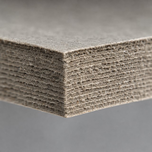 Cut edge of a greyboard stack showing the compressed fibrous core